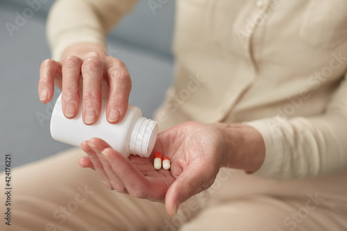 Pills in a senior's hands. Painful old age. Caring for the health of the elderly