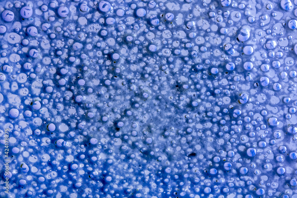 Colorful bubbles of fluid on glass surface Colorful bubbles of fluid on glass surface
