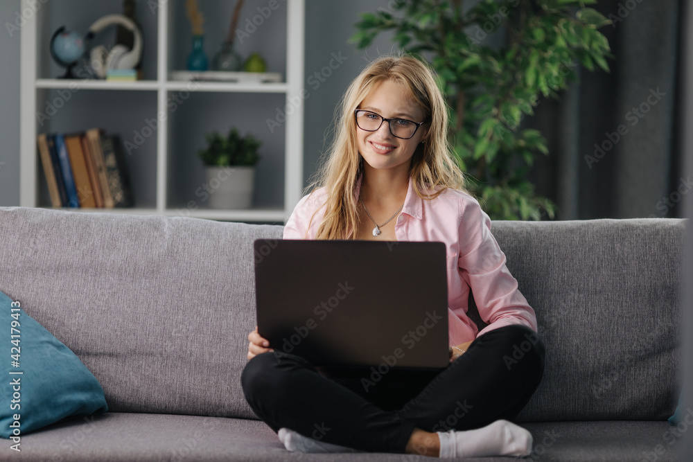 Woman on couch using laptop Woman on couch using laptop