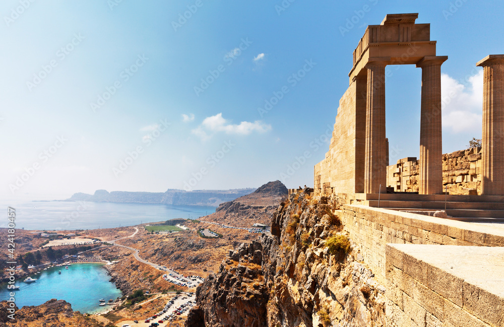 Greece. Rhodes Island. Acropolis of Lindos. View from the height of ancient temple of Athena Lindia IV century BC to St. Paul's Bay in the form of the heart at sunny morning. Mediterranean travel 