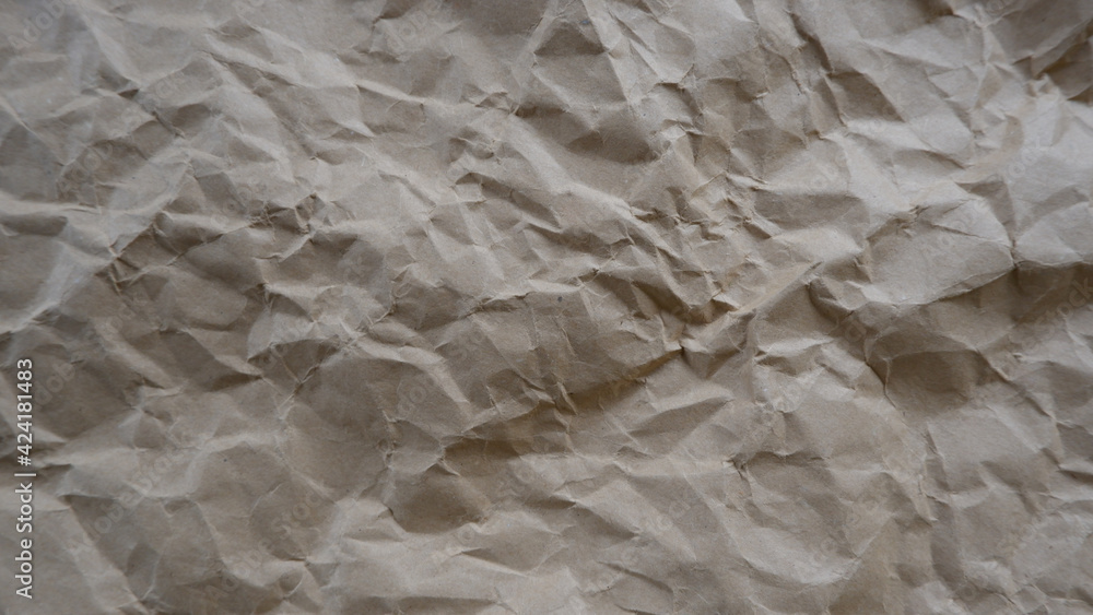 Top view photo of Crumpled craft paper. Paper background with copyspace. Vintage paper canvas texture abstract background. Top view photo of Crumpled craft paper. Paper background with copyspace. Vintage paper canvas texture abstract background.