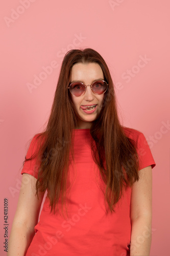 Wallpaper Mural Happy girl in pink glasses on pink background Torontodigital.ca