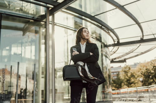 Businesswoman standing in front of office building photo