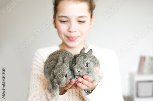 Wallpaper Mural Close-up portrait of young girl with two little gray bunnyes. Symbol of animal care, beauty, love and easter. Torontodigital.ca