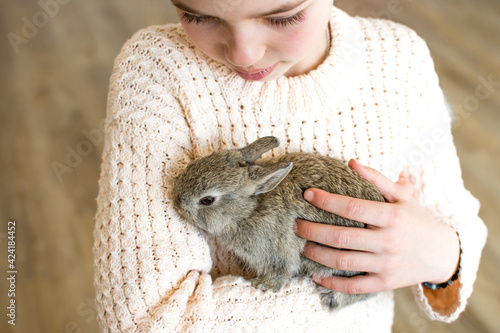 Wallpaper Mural Close-up portrait of young girl with little gray bunny. Symbol of animal care, beauty, love and easter. Torontodigital.ca