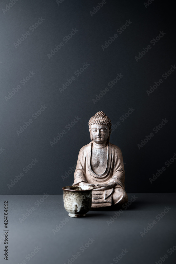 Meditating Buddha Statue on paper background. Copy space. Meditating Buddha Statue on paper background. Copy space.