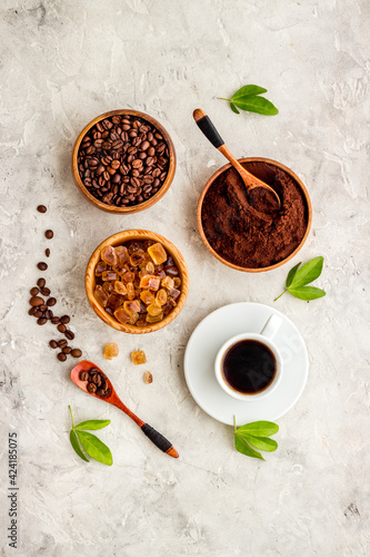 Top view of diffetent varieties of coffee beans with hot drink, top view photo