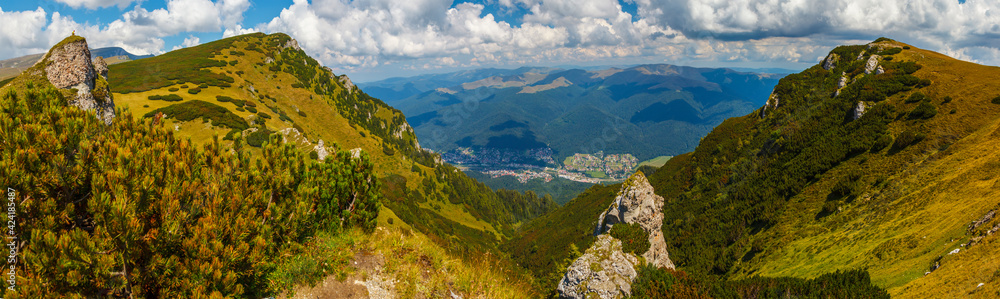 Impressive panorama view on Busteni City from Bucegi mountains, in a summer day, Prahova County, Romania