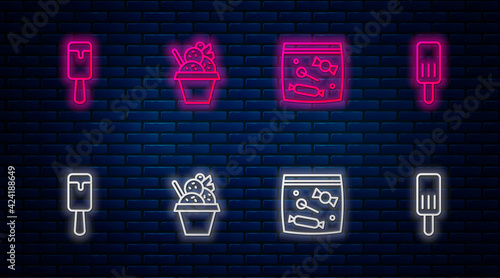 Set line Ice cream in bowl, Candy packaging for sweets, and . Glowing neon icon on brick wall. Vector