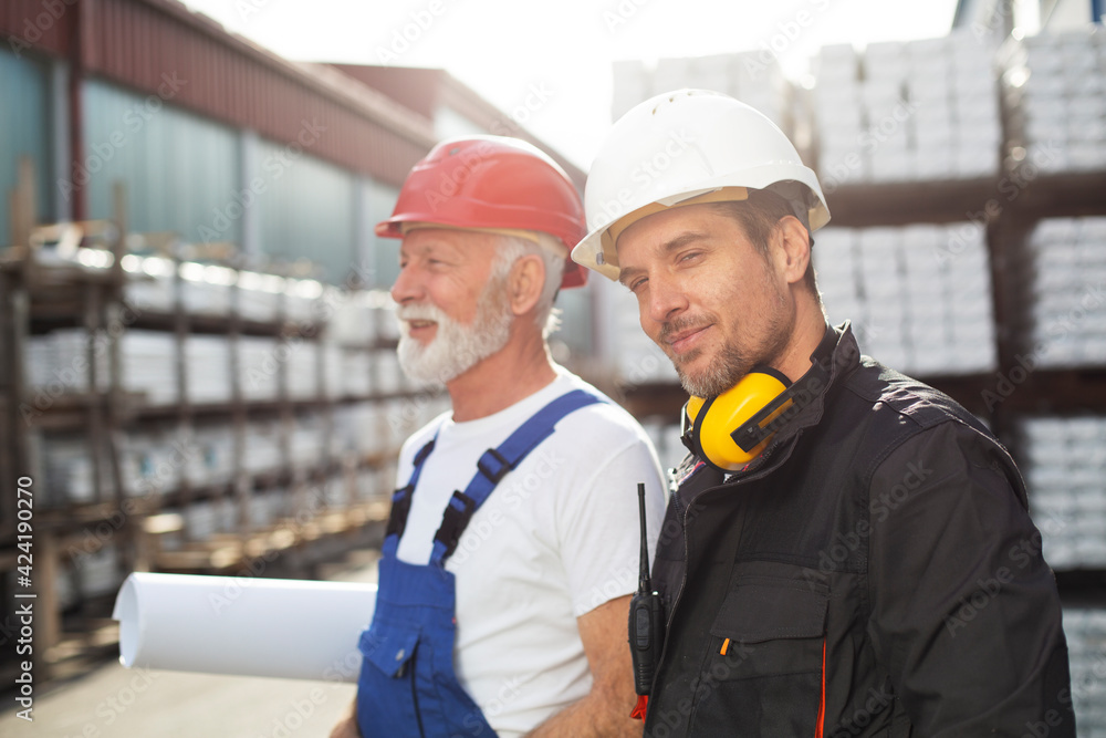 Portrait of workers in factory. Colleagues working in factory Portrait of workers in factory. Colleagues working in factory
