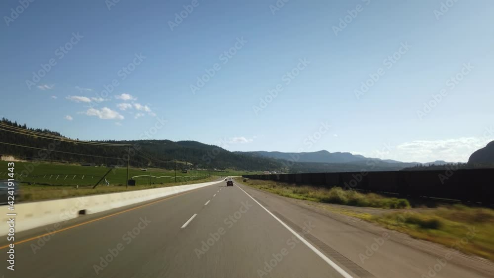 BC, CANADA- JULY 2019: Smooth & steady Driving on British Columbia highway during a sunny day next to farms and train track BC, CANADA- JULY 2019: Smooth & steady Driving on British Columbia highway during a sunny day next to farms and train track