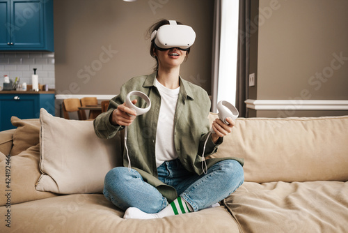 Happy young woman with virtual reality headset