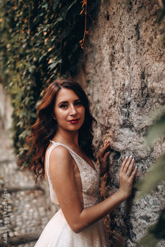 Walking the bride in a white dress through the narrow Italian streets. Travel through the old city. Walking the bride in a white dress through the narrow Italian streets. Travel through the old city.
