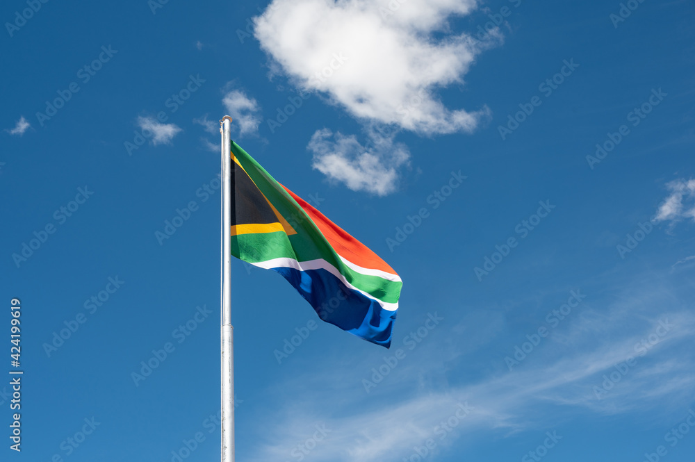 Waving South African flag against blue sky Waving South African flag against blue sky