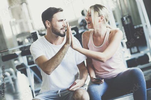 Healthy man and woman fitness exercising session in gym.