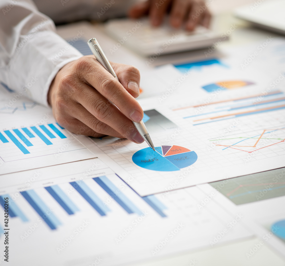Financial Business man analyze the graph of the company's performance to create profits and growth, Market research reports and income statistics, Financial and Accounting concept. Financial Business man analyze the graph of the company's performance to create profits and growth, Market research reports and income statistics, Financial and Accounting concept.