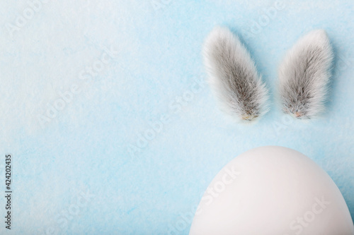Easter rabbit bunny made off egg and pussy willow on blue background © 8H