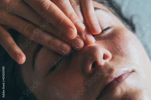 Relaxing massage. SPA treatments for face. Close-up of cosmetic procedures. Woman enjoying massage. 
