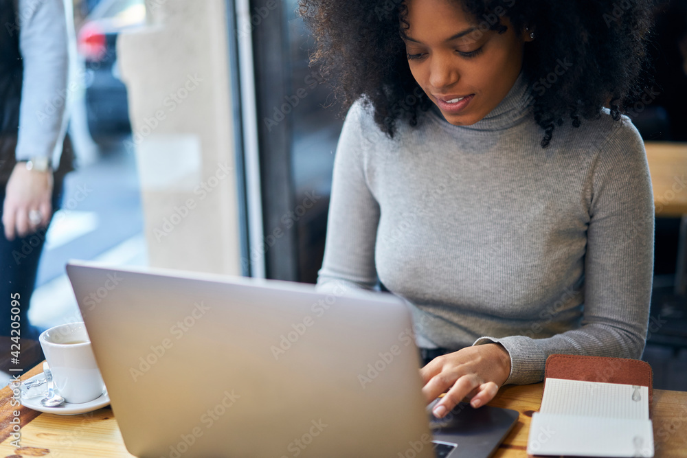 Focused woman typing on laptop Focused woman typing on laptop