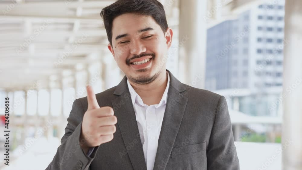 slow motion scene of adult hispanic businessman show thumb up and smile with satisfy feeling for recommend and trust business concept slow motion scene of adult hispanic businessman show thumb up and smile with satisfy feeling for recommend and trust business concept