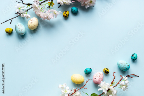 Easter eggs and spring flowers  top view