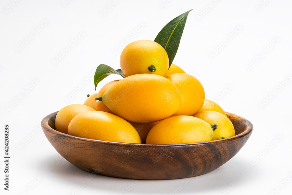 Side view of freshly harvested ripe Marian Plum fruit in wooden bowl on white background with clipping path. Side view of freshly harvested ripe Marian Plum fruit in wooden bowl on white background with clipping path.