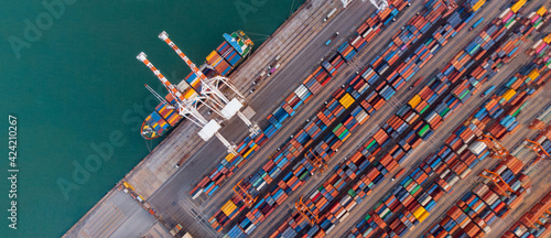 Smart crane loanding cargo container to container ship in the international terminal depot sea yard port concept freight shipping by ship, webinar banner forward mast
