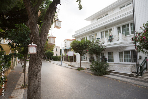 An empty street with white houses and decorative lanterns in an old part of Istanbul, Prince island. Popular travel destination, no tourist at a pandemic time.