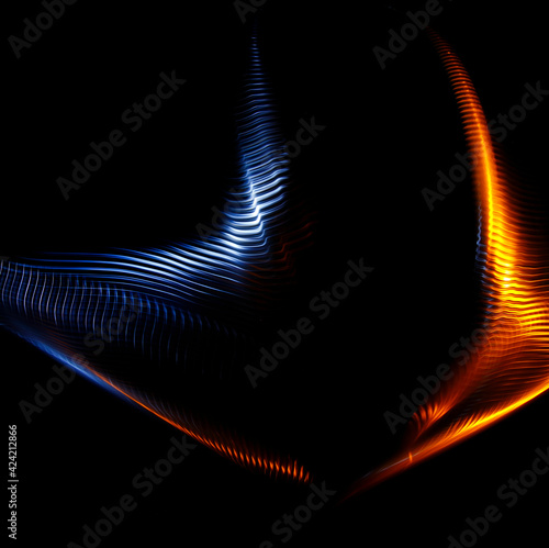 Long exposure photograph of multicolored light trails forming a complex twisted geometric pattern of parallel lines against a dark background. Only photo, no illustration.