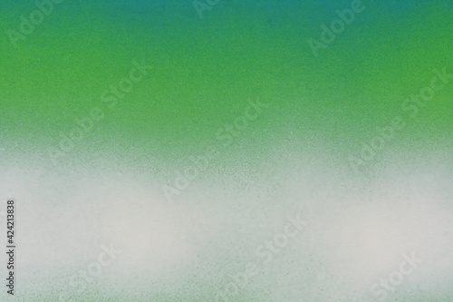 blue and white spray paint on a green colored paper background