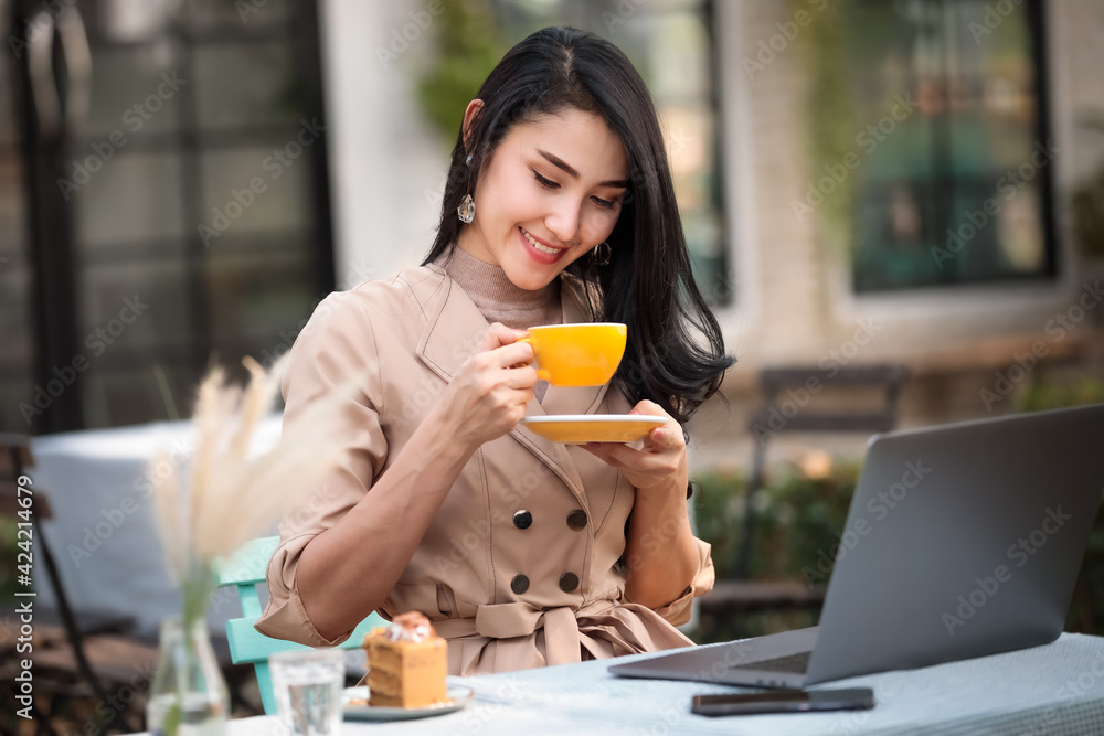 Happy pretty cute woman working with computer enjoying coffee Happy pretty cute woman working with computer enjoying coffee