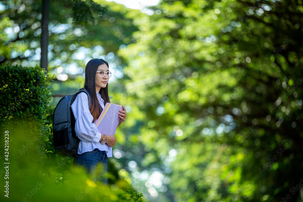 Beautiful female Asian students in trendy clothes chatting on their smartphones to plan their leisure travel. In your mobile phone, documents and notebooks, get ready to record events. Beautiful female Asian students in trendy clothes chatting on their smartphones to plan their leisure travel. In your mobile phone, documents and notebooks, get ready to record events.