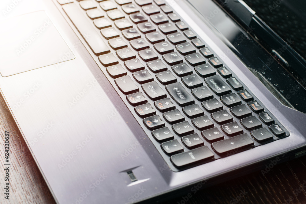 Laptop on a dark wooden table, copy space. Remote study or work concept, quarantine covid 19. Laptop on a dark wooden table, copy space. Remote study or work concept, quarantine covid 19.