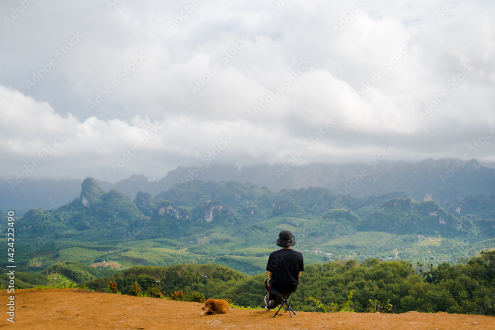 solo hiker man relax on top of mountain with his dog solo hiker man relax on top of mountain with his dog