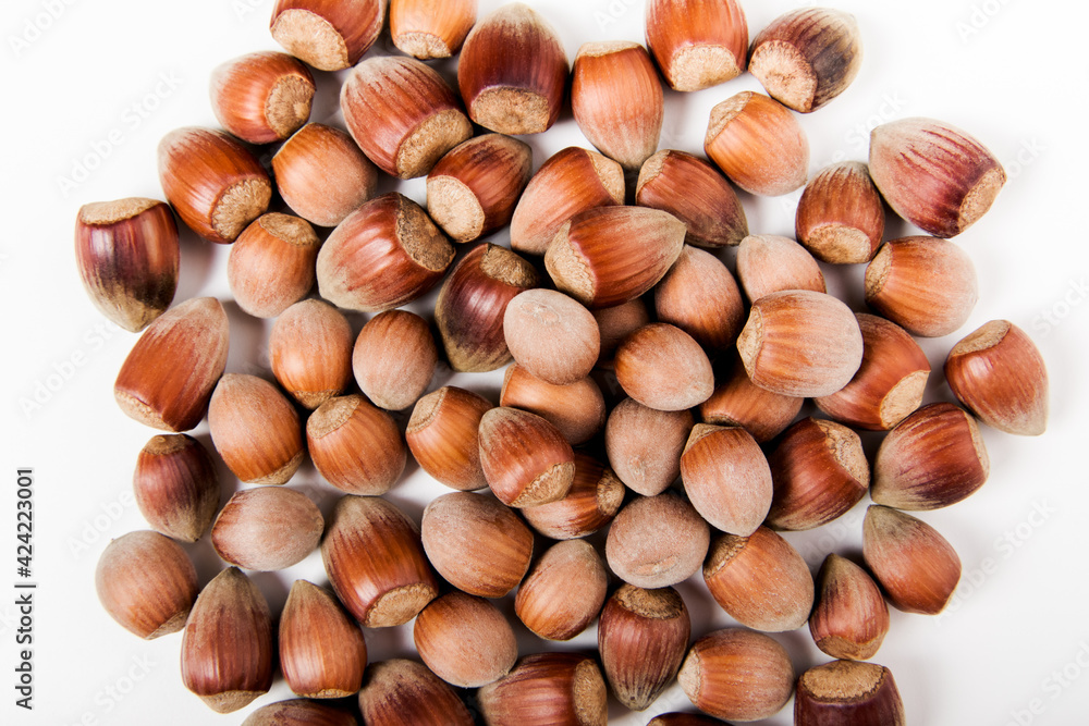 flatlay of whole unpeeled hazelnut on the white background. close-up view flatlay of whole unpeeled hazelnut on the white background. close-up view