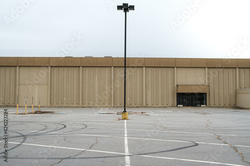 Empty parking lot by an abandoned department store. North Carolina.