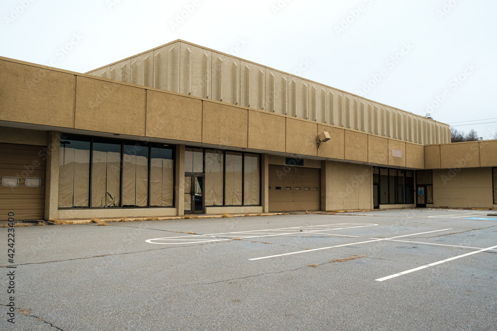 Empty parking lot by an abandoned department store. North Carolina. Empty parking lot by an abandoned department store. North Carolina.