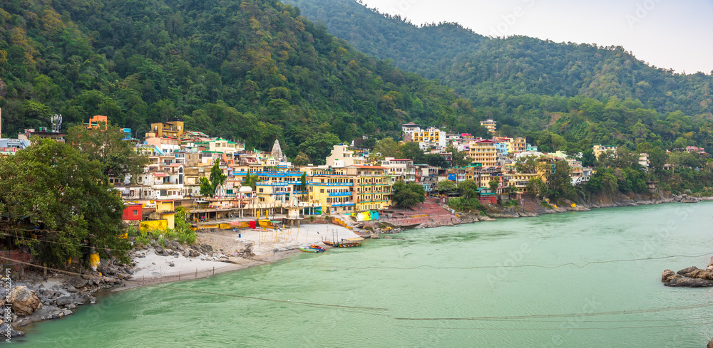 Spectacular panoramic cityscape of Rishikesh, the yoga capital of World located in foothills Himalayas along banks of river Ganga or Ganges in Uttarakhand state of India.