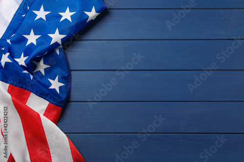 American flag on blue wooden table, top view with space for text. Memorial Day