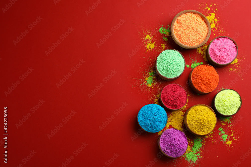 Colorful powders in bowls on red background, flat lay with space for text. Holi festival celebration Colorful powders in bowls on red background, flat lay with space for text. Holi festival celebration