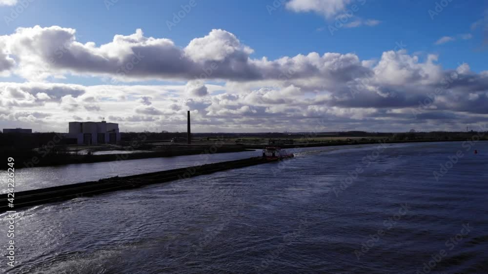 Empty Barge Ship Traveling Across The River Canal Of Oude Maas In Puttershoek, Western Netherlands. - Aerial Shot Empty Barge Ship Traveling Across The River Canal Of Oude Maas In Puttershoek, Western Netherlands. - Aerial Shot