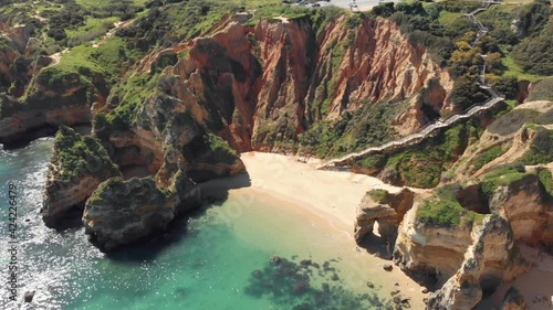Secluded sand beach surrounded by cliffs, Lagos , Algarve.  Long wooden walkway access.