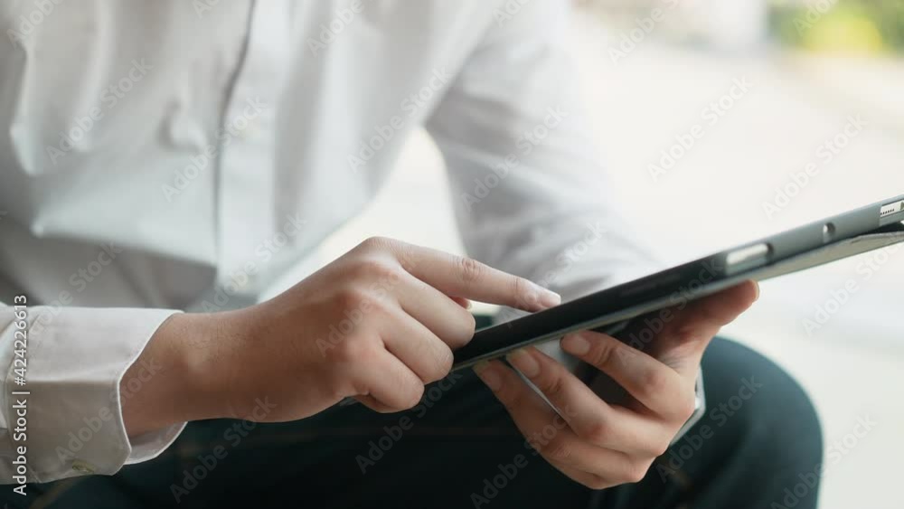 slow motion of investor man using digital tablet screen to check stock market news and data and profit from statistics dashboard at private room at home for financial concept slow motion of investor man using digital tablet screen to check stock market news and data and profit from statistics dashboard at private room at home for financial concept