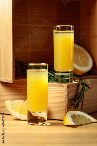Limoncello on a wooden table.