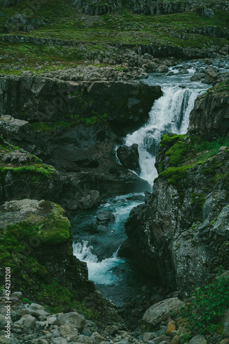 Beautiful nature dramatic landscape in Iceland. Waterfall in mountains. Cold toned filter