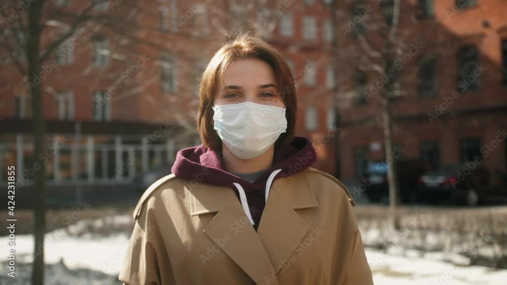 Close up portrait of attractive woman in protective medical mask during quarantine due to covid-19 coronavirus pandemic. Portrait outdoor. Close up portrait of attractive woman in protective medical mask during quarantine due to covid-19 coronavirus pandemic. Portrait outdoor.