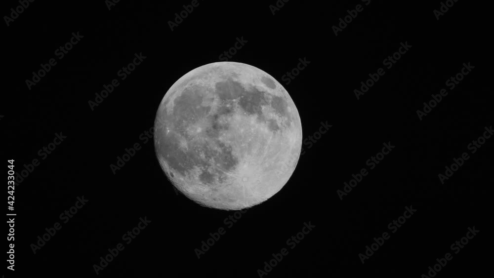 Full moon moves quickly in the dark sky. Beautiful big month Full moon moves quickly in the dark sky. Beautiful big month