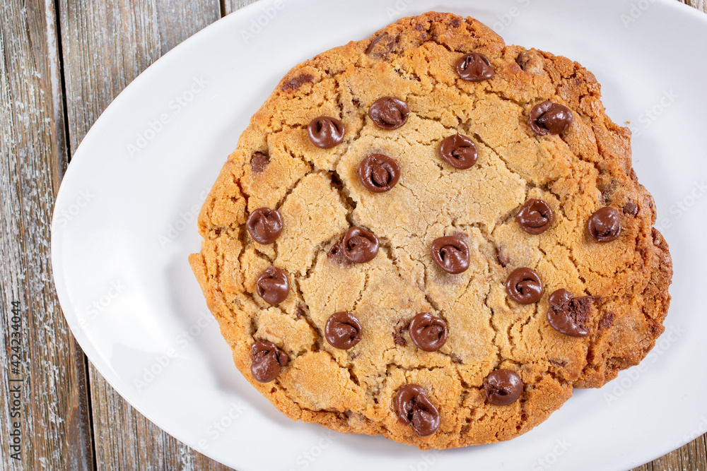 A top down view of a large chocolate chip cookie. A top down view of a large chocolate chip cookie.