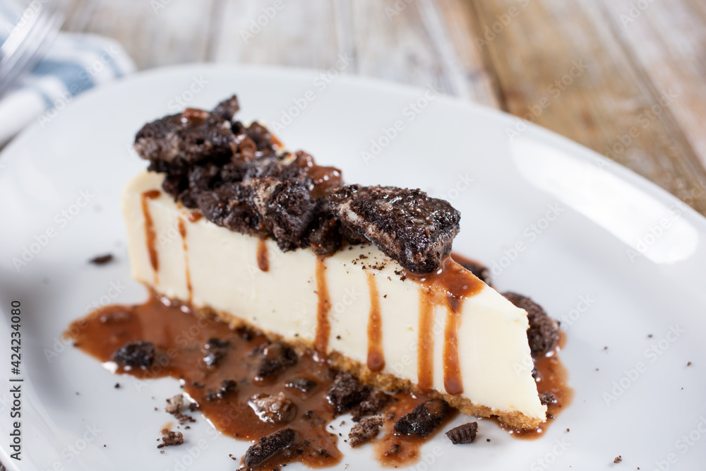 A closeup view of a slice of cookies and cream cheesecake. A closeup view of a slice of cookies and cream cheesecake.