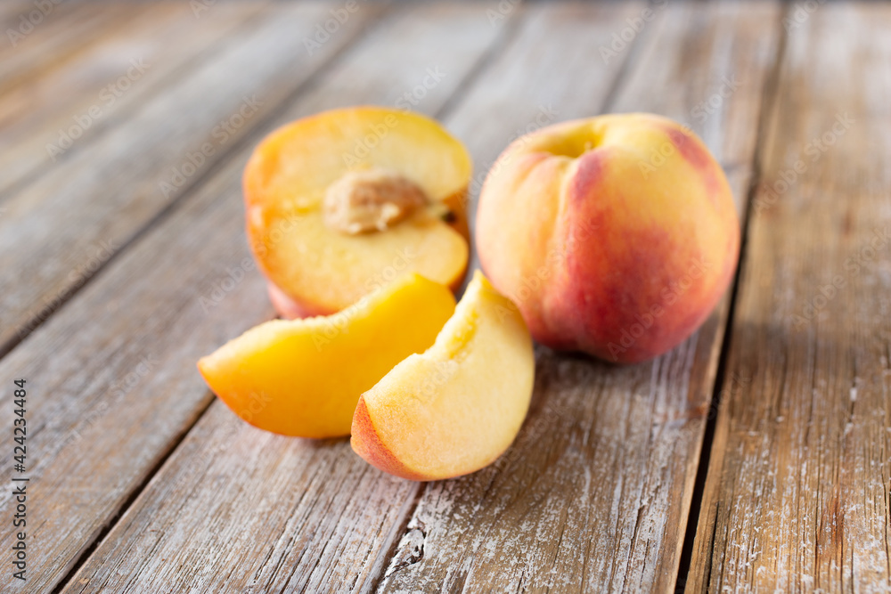 A view of peach parts in a group on a wood table surface.